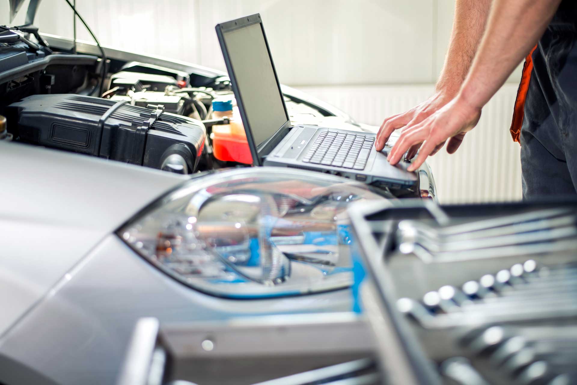 Automotive diagnostic technician running a scan on a damaged vehicle | Parkville Auto Body