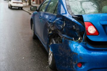 Blue auto sedan with heavily damaged left quarter panel | Parkville Auto Body