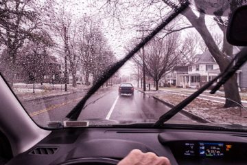 Driver turns on windshield wipers during a rainy day | Parkville Auto Body