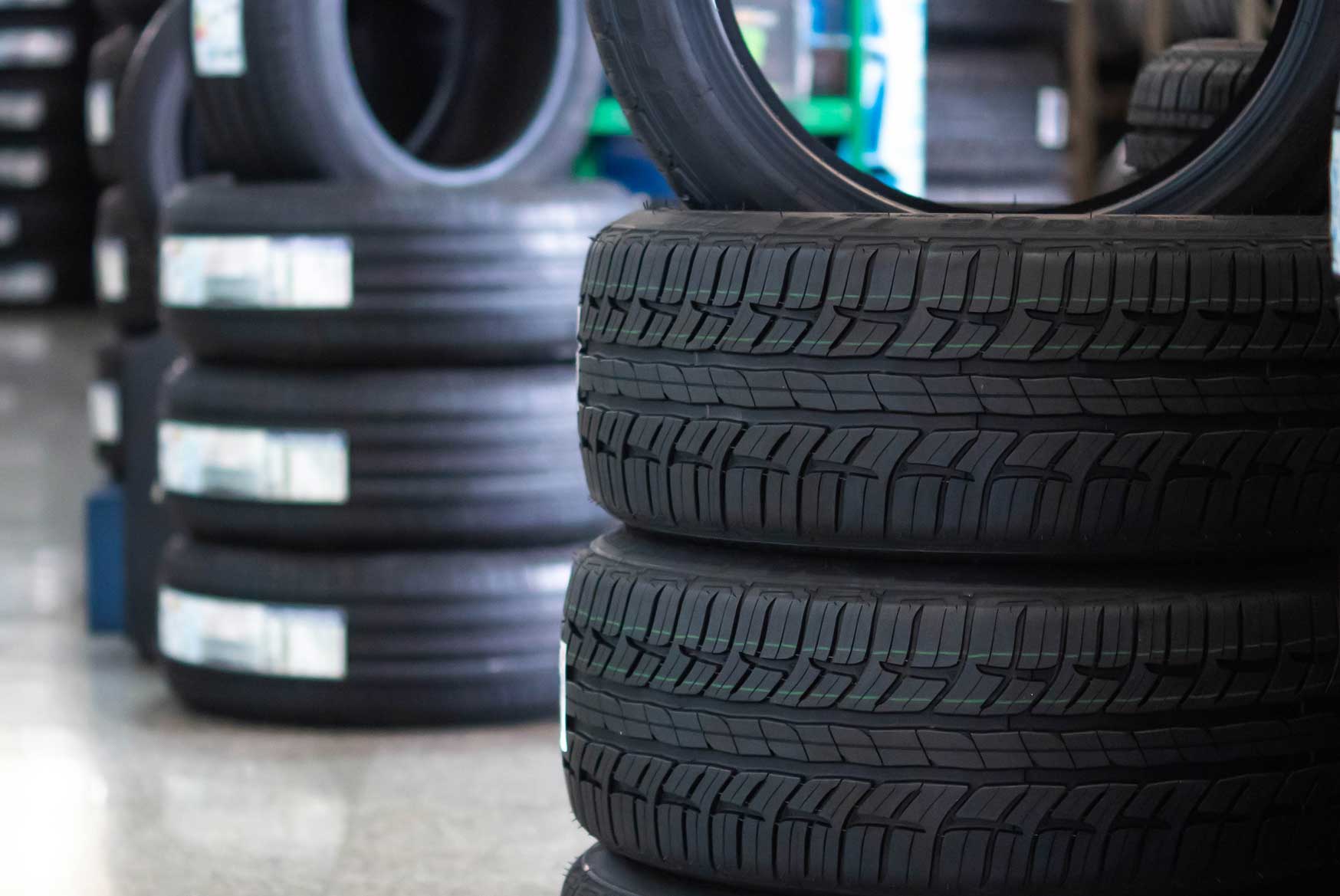 Car tires stacked up on the shop floor | Parkville Auto Body