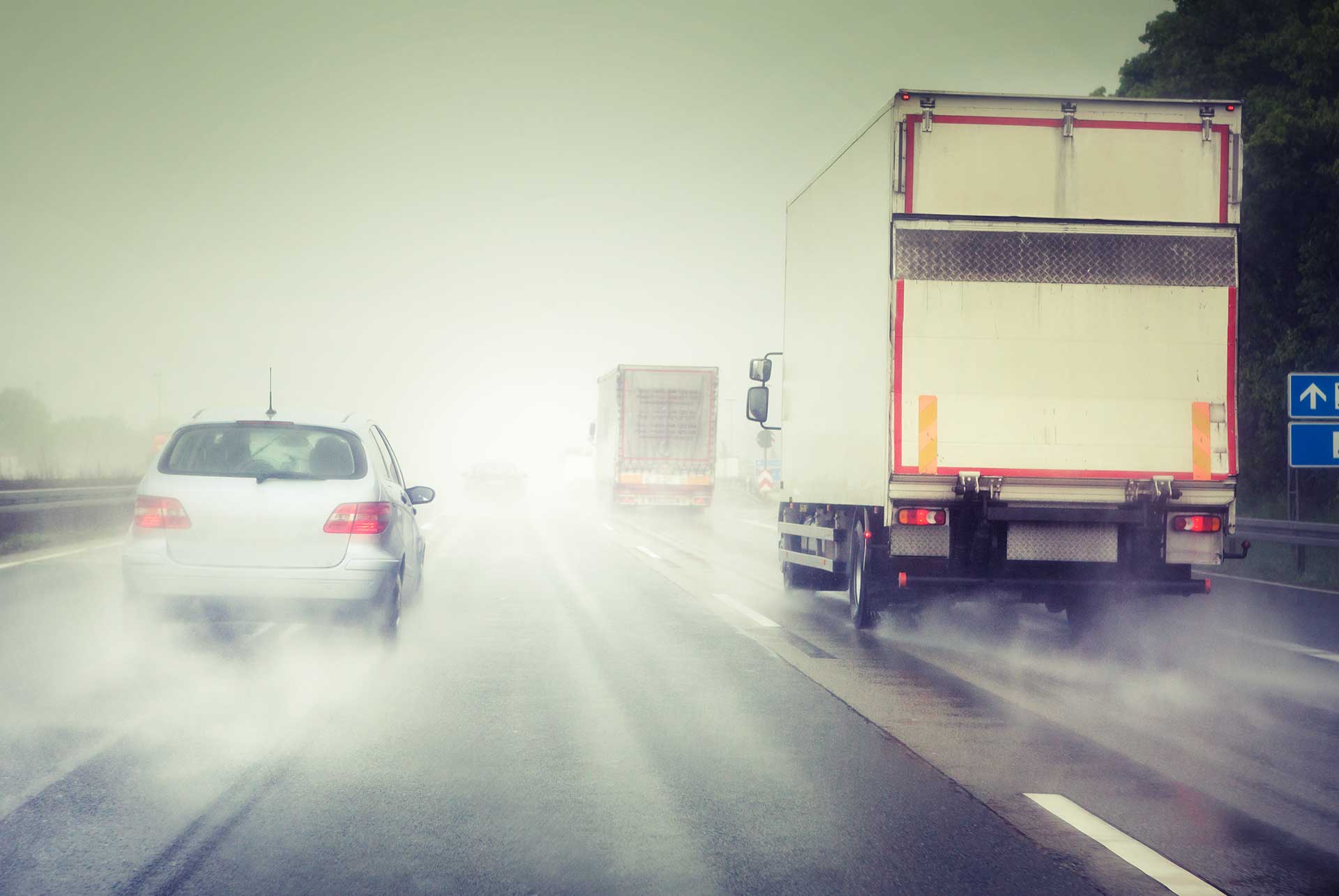 Vehicles driving down the highway on a rainy day | Parkville Auto Body